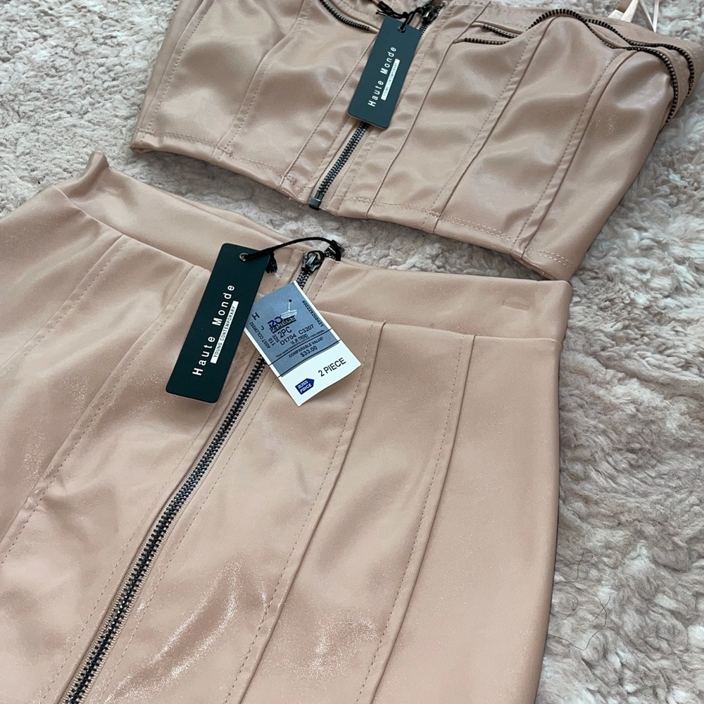 Brand new. Two piece skirt and crop top.zipper down the middle. Pink pleather.